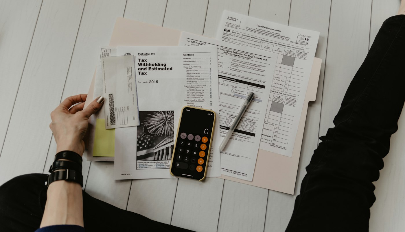 Desk with calculator and financial documents ready for tax and accounting work
